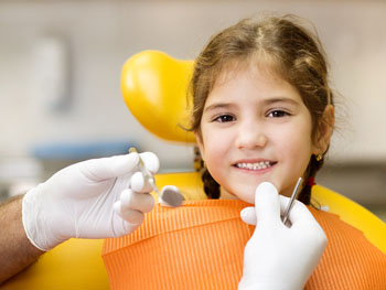 Girl getting her teeth examed